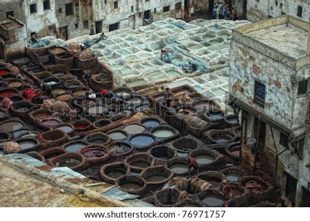 FEZ, MOROCCO - SEPTEMBER 20: Local people painting leather at the tannery by the ancient way at September 20, 2008 in Fez, Morocco.