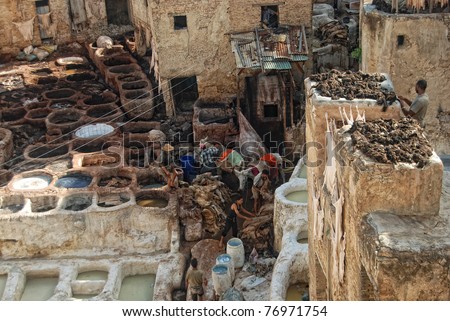 FEZ, MOROCCO - SEPTEMBER 20: Local people painting leather at the tannery by the ancient way at September 20, 2008 in Fez, Morocco.