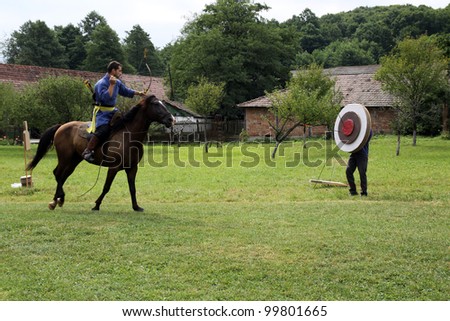 VALCELE, ROMANIA - AUGUST 11: An unidentified Hungarian rider demonstrates archery on horseback at the yearly organized \