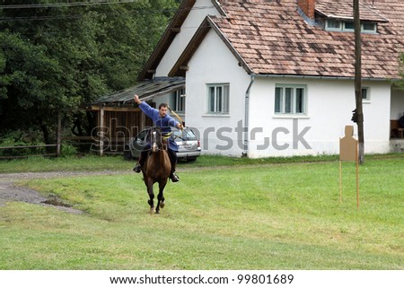 VALCELE, ROMANIA - AUGUST 11: An unidentified Hungarian rider demonstrates archery on horseback at the yearly organized \