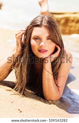 Bright portrait of a brunette resting at sea coast