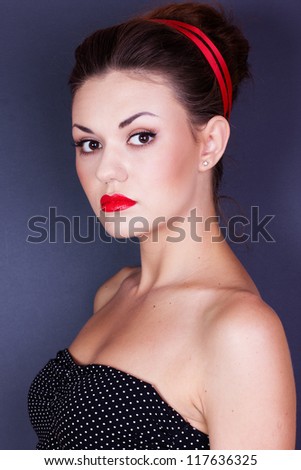 Pin-up girl with red ribbon in her hairs