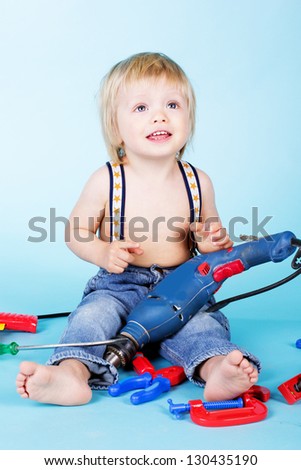 Little baby boy play with build tools