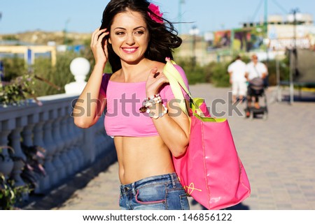 Pretty woman with the pink beach bag