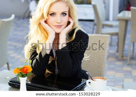 Young pretty business blonde woman with notebook