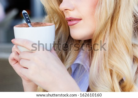 Portrait of beautiful woman drinking coffee