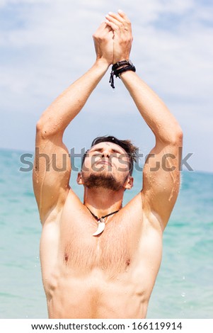 Portrait of cute young man on the beach