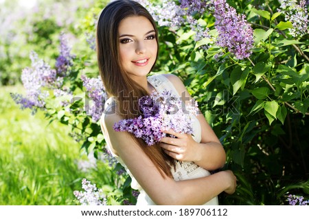 Beautiful girl with a lilac flowers