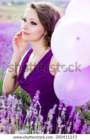 Adorable girl with purple balloons.