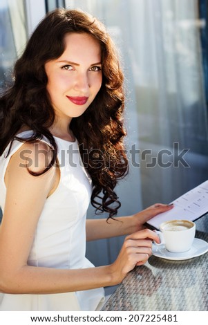 Girl spending time in a cafe using digital tablet
