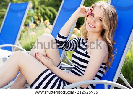 Beautiful woman is resting on the deck chair