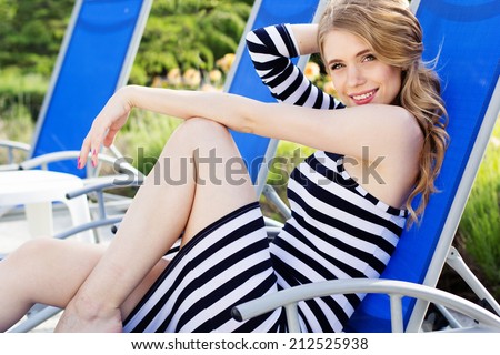 Beautiful woman is resting on the deck chair