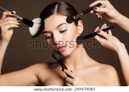 Visagist apply makeup for naturally beautiful woman