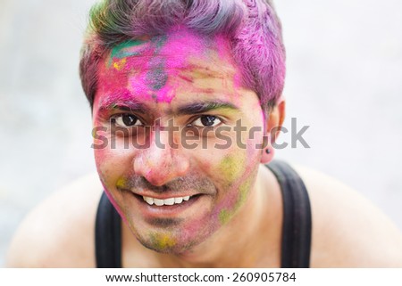 Portrait of an emotional boy with paint on his face, India, Holi festival, Rishikesh