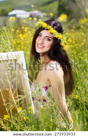 Young female artist is create picture of an floral landscape, summer time