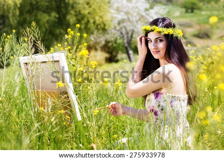 Young female artist is create picture of an floral landscape, spring time