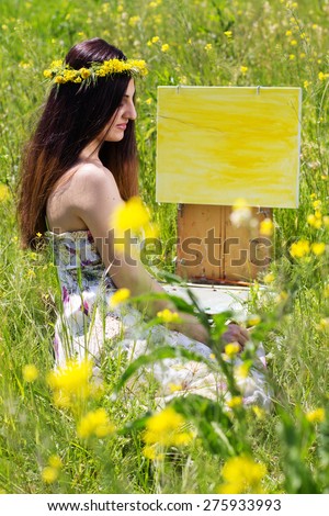 Young female artist painting an floral landscape, summer time