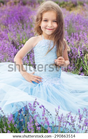 Portrait of cute little girl is resting in a lavender field