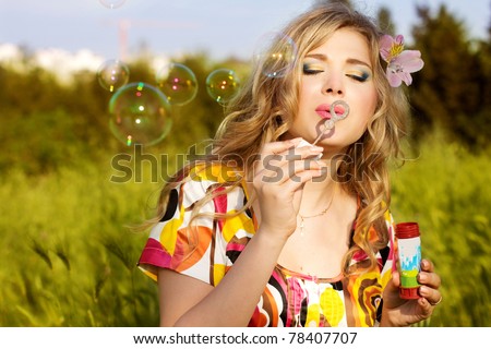 Young girl makes soap bubble