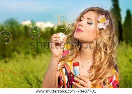 Young girl makes soap bubble