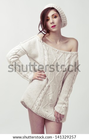 female fashion model wearing white sweater and winter white hat