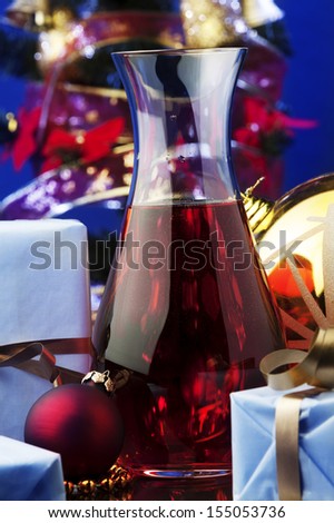 jug of rose wine and Christmas decoration against color background