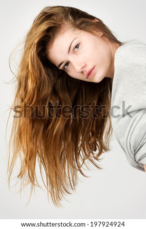 beauty fashion girl red hair against light grey background