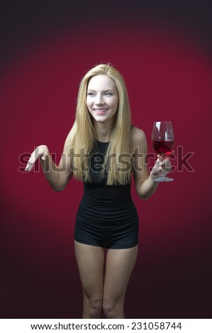 beauty blond  model holding wineglass with red wine smiling and making gesture with hand