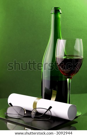 red wine glass, bottle, diploma, certificate of graduation and glasses