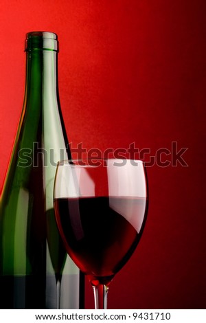 a glass and a bottle with red wine  details
