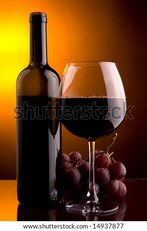 red wine glass and bottle and grape