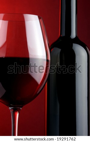 a glass of red wine and a bottle details