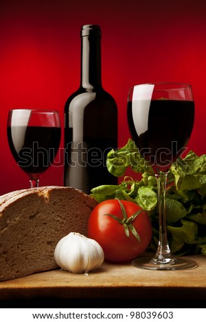 red wine,rye bread,garlic,green spinach, colored background