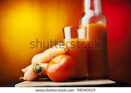 natural juice,glass,carrot,tomato,colored background