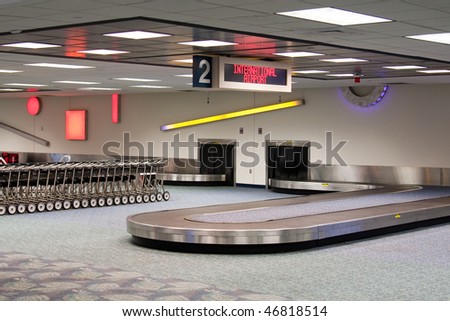 Empty baggage claim carousel.  International Airport.  Baggage cars.  Waiting for the plane to land and unload.
