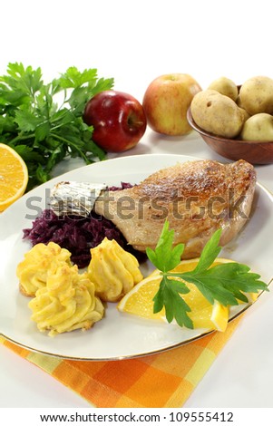 Duck leg with red cabbage and duchess potatoes