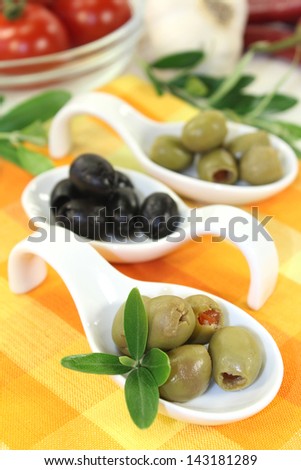 Olives with olive leaves on a spoon