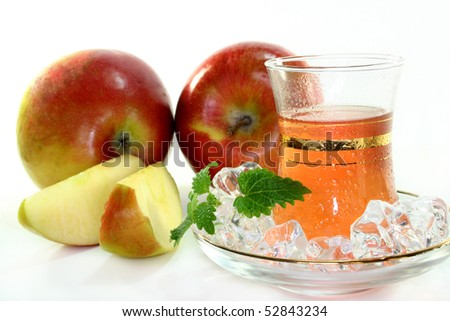 a cup of apple tea with fresh apple and lemon balm