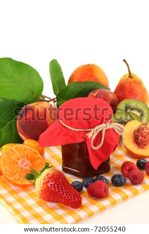 a pot of jam and fresh fruit on a white background