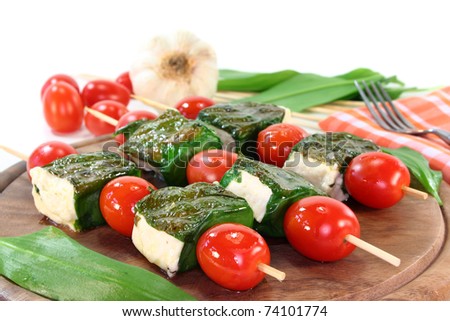 Feta cheese wrapped in wild garlic and cherry tomatoes