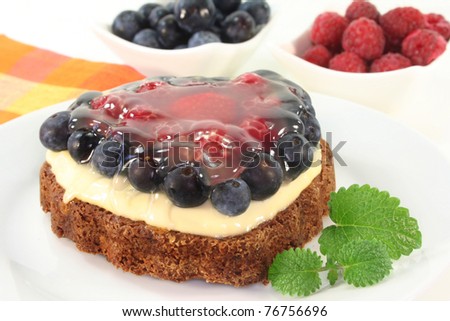 a forest fruit tarts on a cake server
