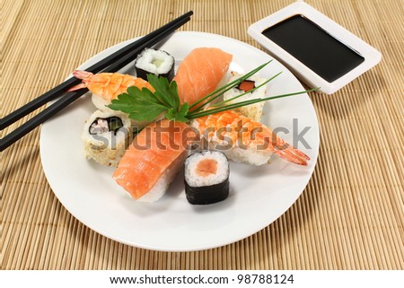 variety of sushi with parsley and chives