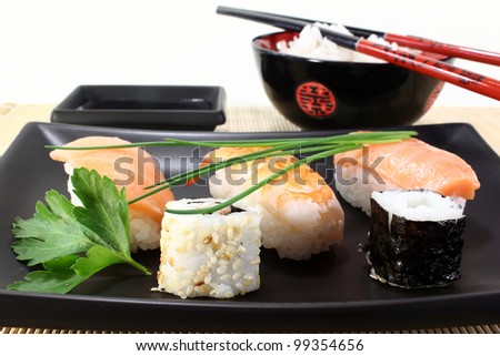variety of sushi with parsley and chives