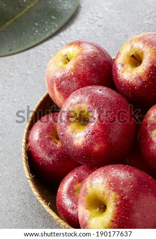 Fresh harvest of apples.with basket on stone background