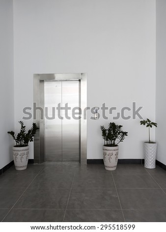 Front view of a office elevator with closed doors in lobby