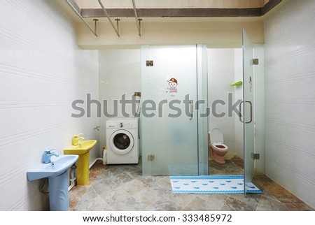 Children and Family home interiors,kindergarten bathroom with washbasins and cabins without children