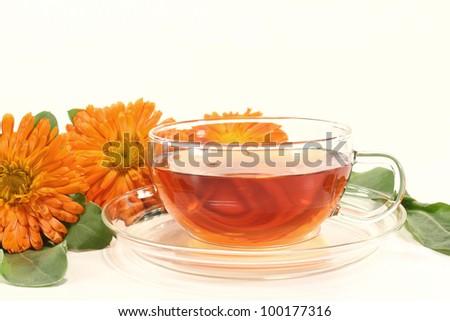 marigold tea with flowers and leaves on a bright background