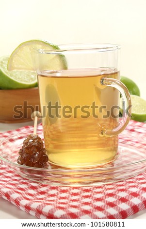 fresh hot lemon tea in a glass with candy on napkin