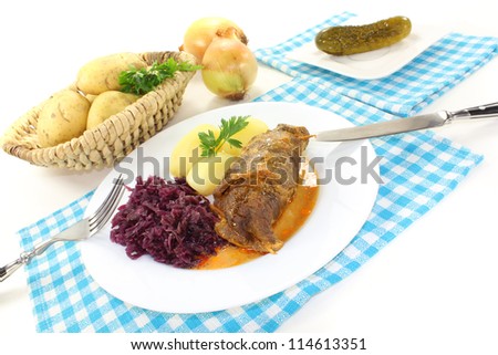 fresh cooked Beef roulade with potatoes and red cabbage on a light background