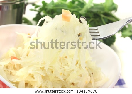 delicious Sauerkraut on a fork before light background